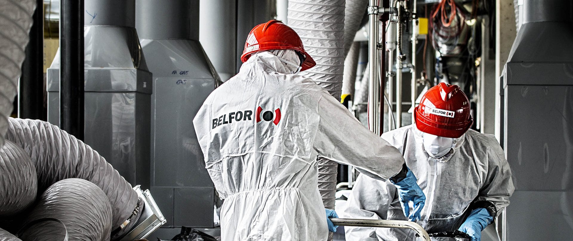 Two BELFOR employees wearing PPE suits and hard hats